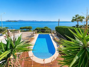 A rectangular swimming pool with a view of the sea and mountains in the background. - Villa Casa Faro - Four Bedroom Villa, Sleeps 8 (Mallorca)