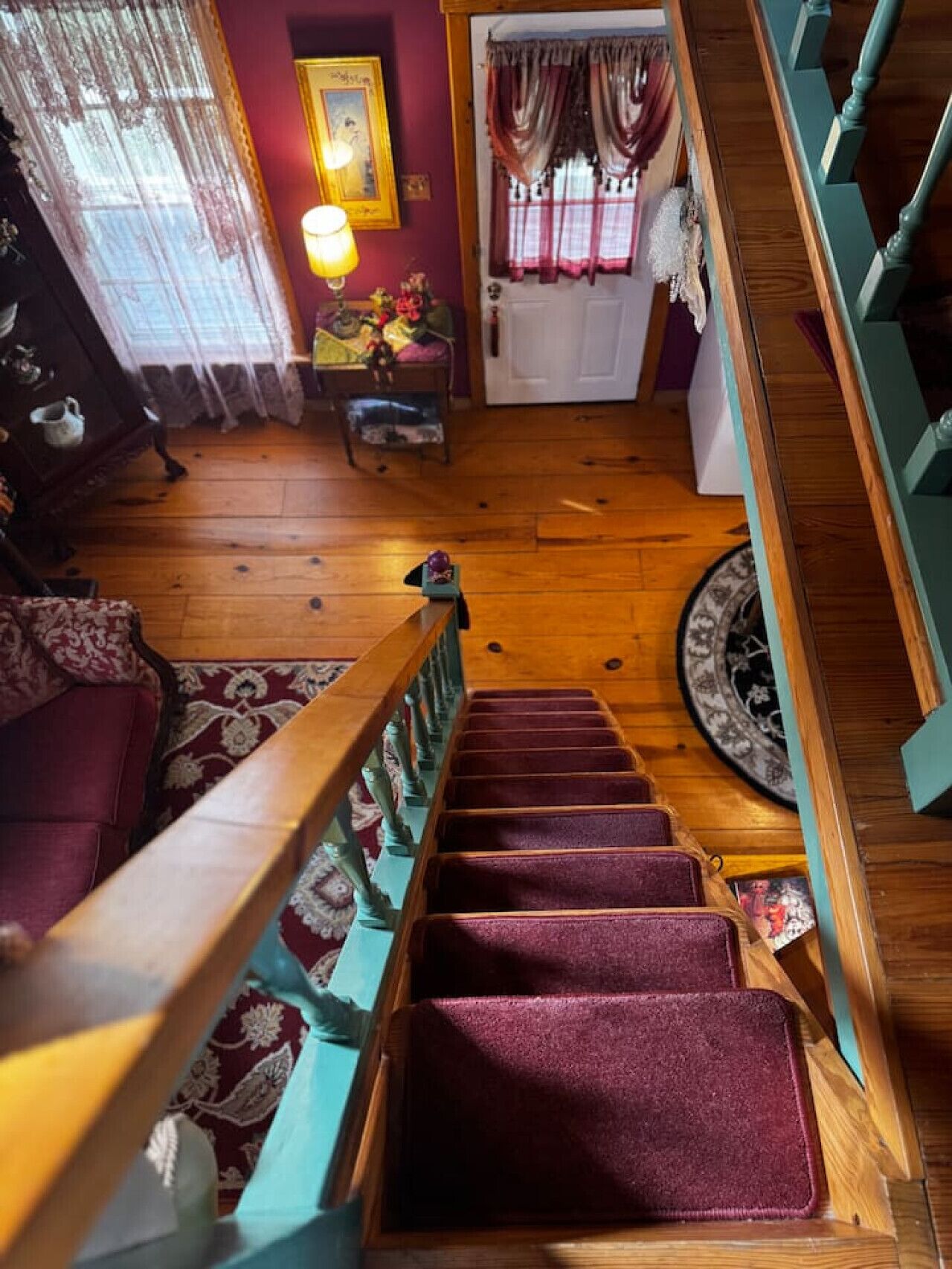 A staircase with wooden railings and a carpeted landing.