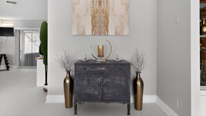 A modern living room with a dark wooden console table, two decorative vases, and a large abstract painting on the wall. - Work, Play or Recharge:3BR Pool Home near Legoland (Winter Haven)