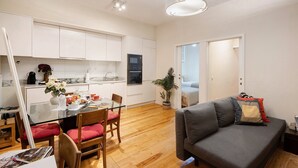 Um apartamento moderno com sala de jantar, cozinha e sala de estar.