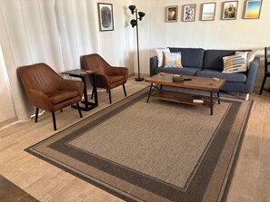 A living room with a sofa, two armchairs, a coffee table, and a rug. - Centrally located Tucson home, renovated 2 bedroom/1 bath home. (Tucson)