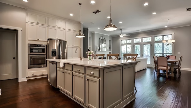 A modern kitchen with white cabinetry, stainless steel appliances, and a large island. - 3-bedroom townhome in adorable Mableton. Close to all the charms of Atlanta. (Mableton)