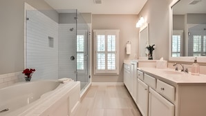 A modern bathroom with a glass-enclosed shower, a large mirror, and a vanity with a sink and countertop. - 3-bedroom townhome in adorable Mableton. Close to all the charms of Atlanta. (Mableton)
