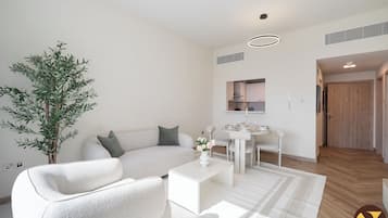 Luxury Apartment, Balcony, Pool View | Living area | 65-inch Smart TV with cable channels