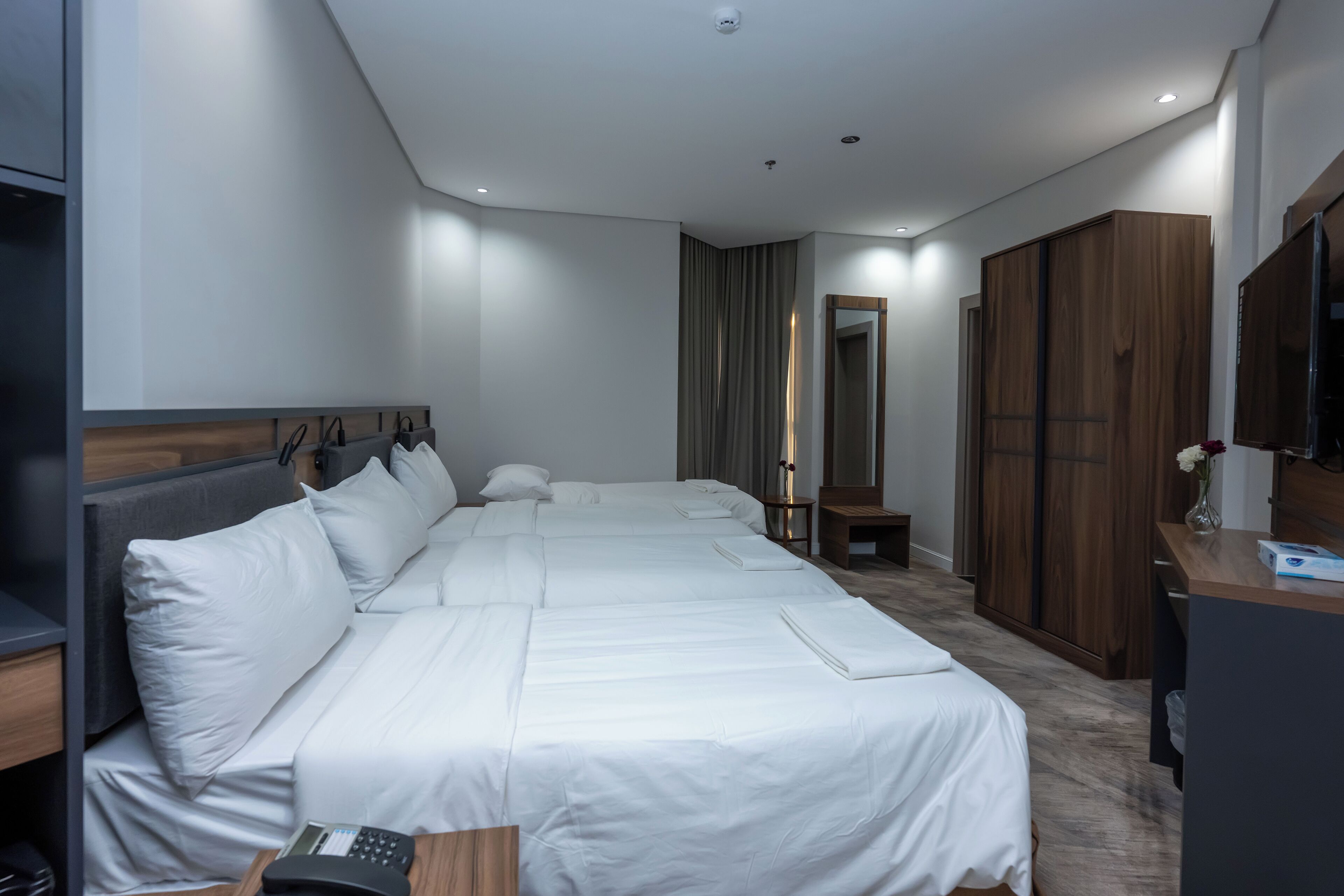 Deluxe Quadruple Room, Balcony, City View | Free WiFi, bed sheets