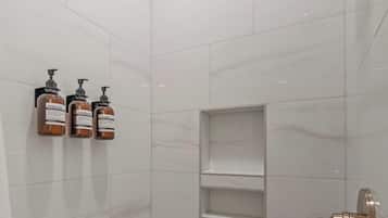 Shower, hair dryer, towels, shampoo
