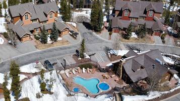 A residential area with houses, a swimming pool, and a parking lot.