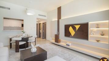 Luxury Apartment, Balcony, Pool View | Living area | 65-inch Smart TV with cable channels