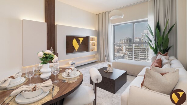 A modern hotel room with a dining area, a sofa, a large window with a city view, and a mounted artwork on the wall. - Vogue | Jeewar By Badr JVC near Circle Mall (Dubai)