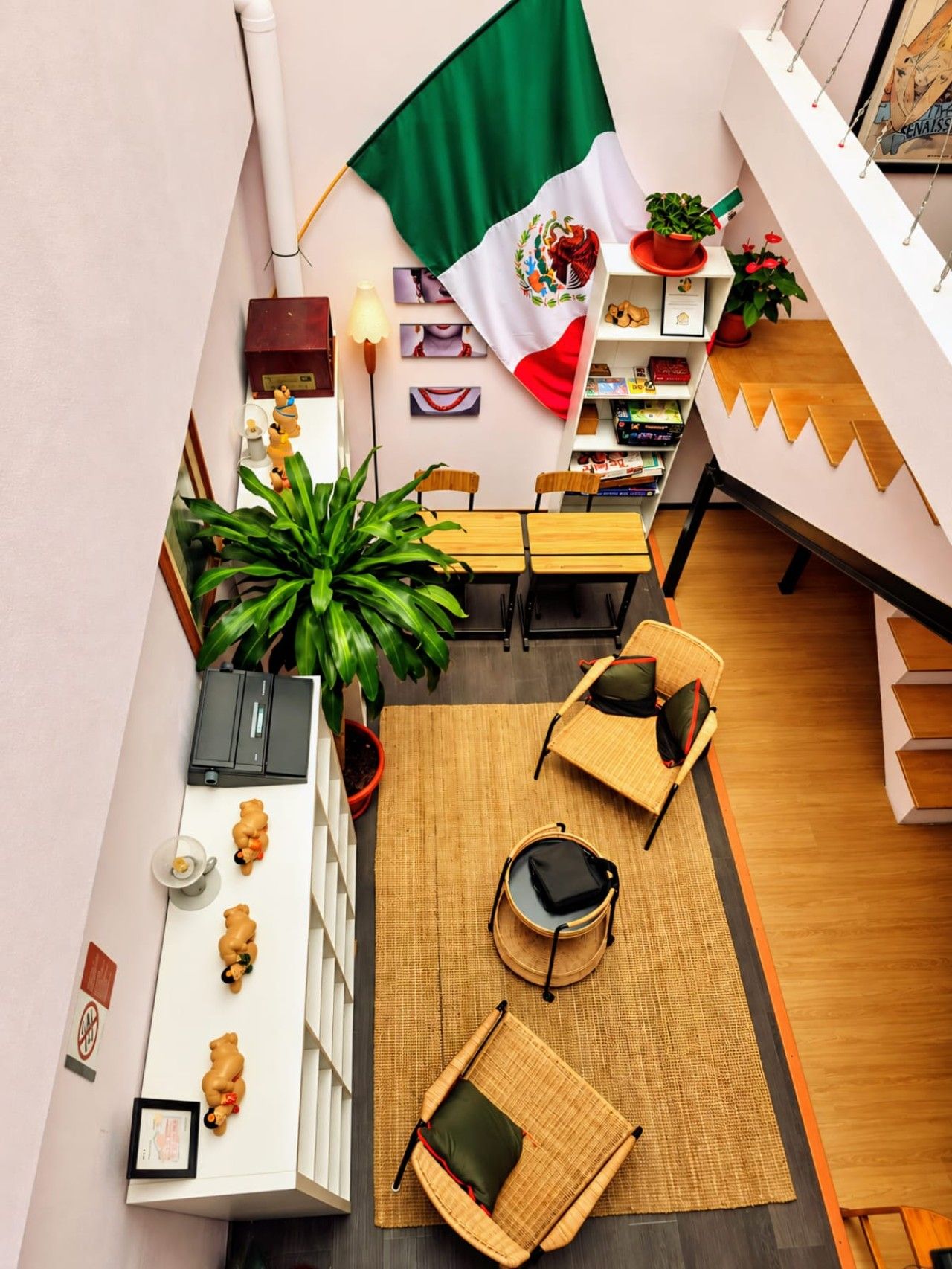 A spacious room with a dining area, a flag, and a bookshelf.