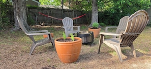 Outdoor seating with chairs and planters.