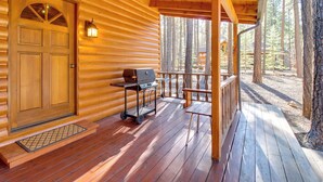 A wooden cabin with a porch, a grill, and a lantern. - Bear's Den 2 Mi to Pinetop CC: Ski, Sled, Hike! (Pinetop Country Club)