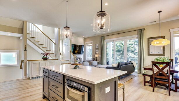 A spacious kitchen with a central island, stainless steel appliances, and pendant lighting. - Walk to Water & Greenway! Luxe Carolina Beach Home (Carolina Beach)