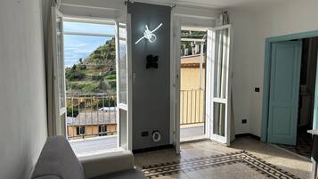 Suite Panoramique, plusieurs lits, balcon, vue mer | Coin séjour