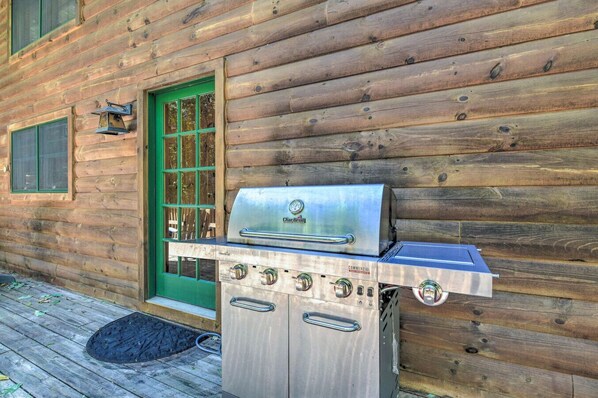 A commercial Char-Broil grill attached to a wooden cabin. - 5 BR Luxury Log Cabin | Game Room + 2 Decks (Sapphire)