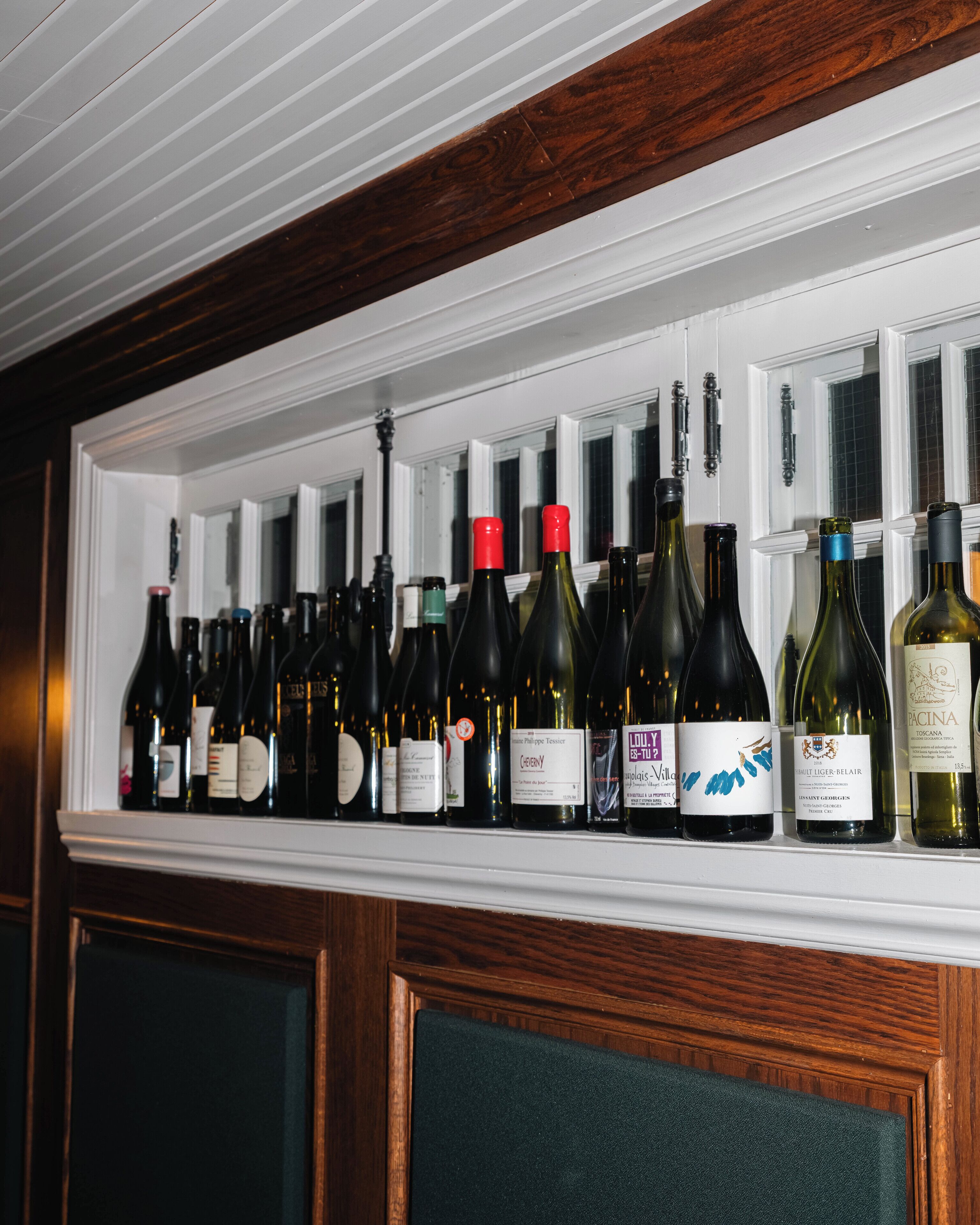 A wine rack with various bottles of wine.
