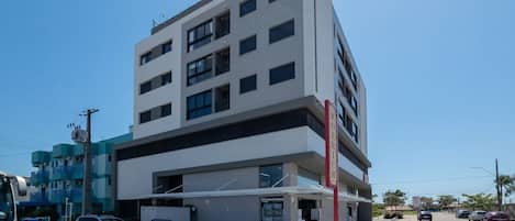 A multi-story building with a flat facade, large windows, and a visible entrance.