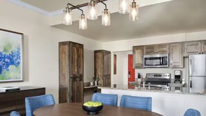 A modern kitchen with wooden cabinets, a microwave, a stove, and a refrigerator. - Charming 1-bedroom villa with AC in fantastic San Antonio (San Antonio)
