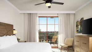 A hotel room with a large bed, a ceiling fan, a TV, a balcony with a chair, and a view of the outdoors. - Charming 1-bedroom villa with AC in fantastic San Antonio (San Antonio)