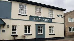 A two-story building with a sign reading "Miles Arms Hotel." - The Miles Arms Hotel (Bristol)