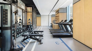A gym with treadmills, weight machines, and dumbbells. - Four Points By Sheraton Guangzhou Bai’E Tan (Guangzhou)