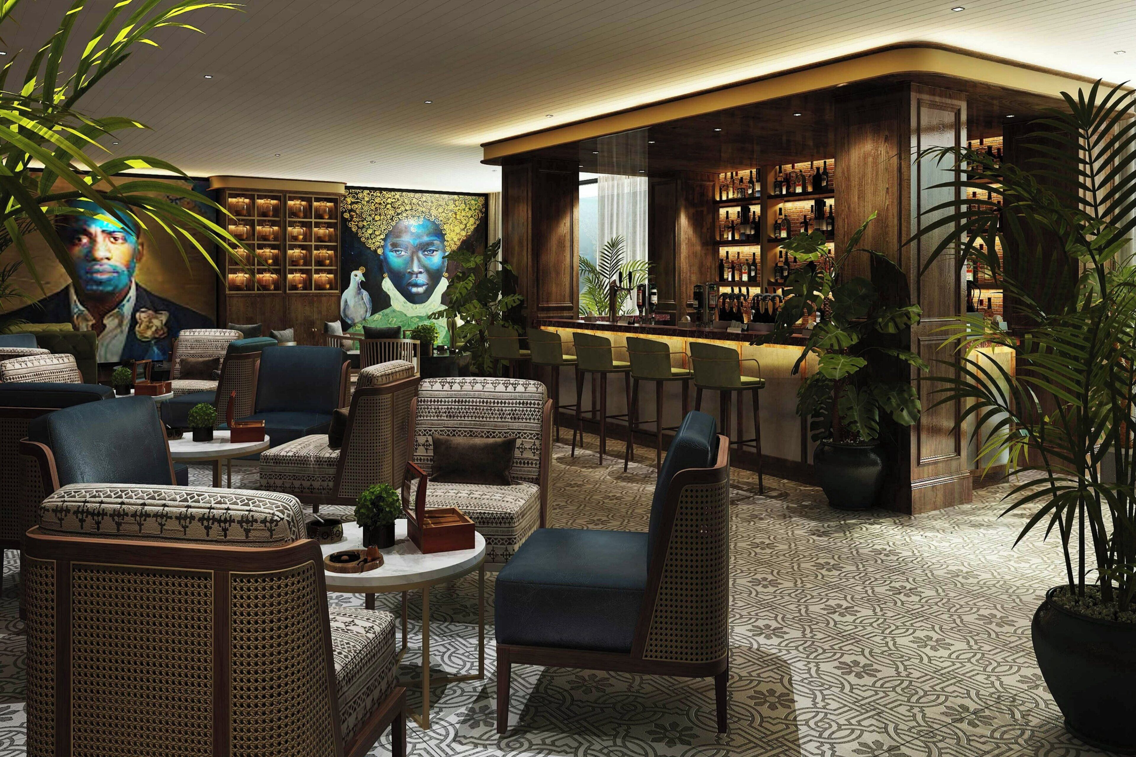 A bar area with seating and a mural.