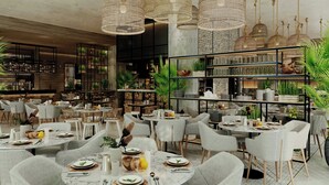 A restaurant with round tables, grey chairs, and hanging wicker chandeliers. - Kampala Marriott Hotel (Kampala)