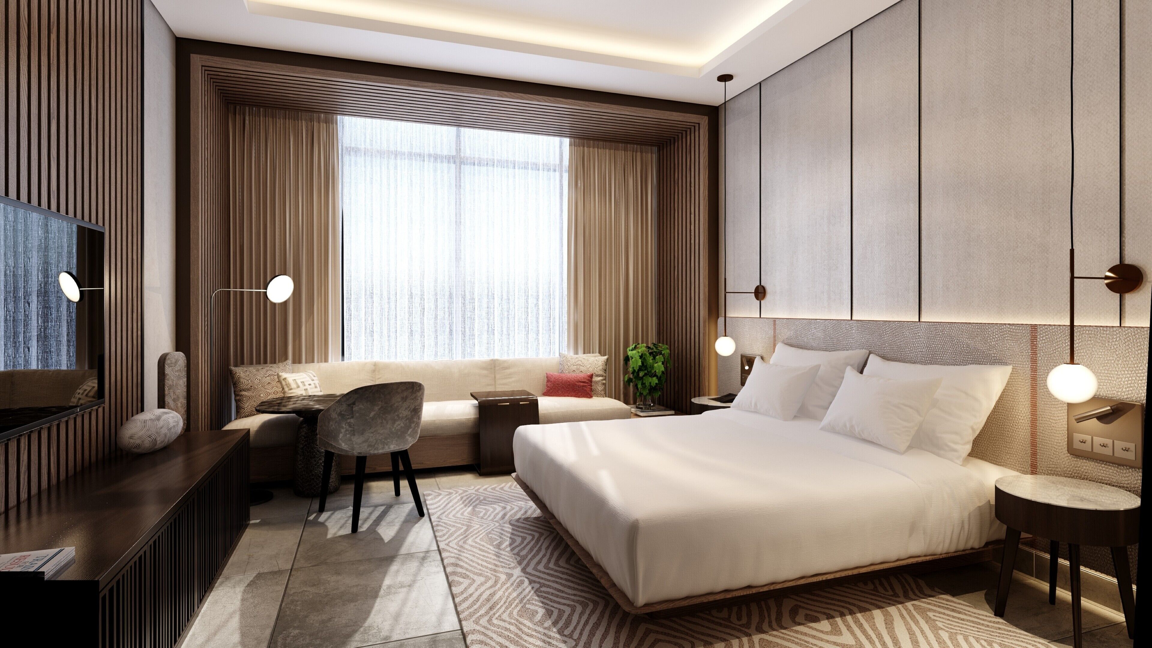 A modern hotel room with a large bed, a sofa, a desk, and a TV.
