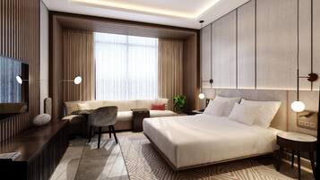 A modern hotel room with a large bed, a sofa, a desk, and a TV.