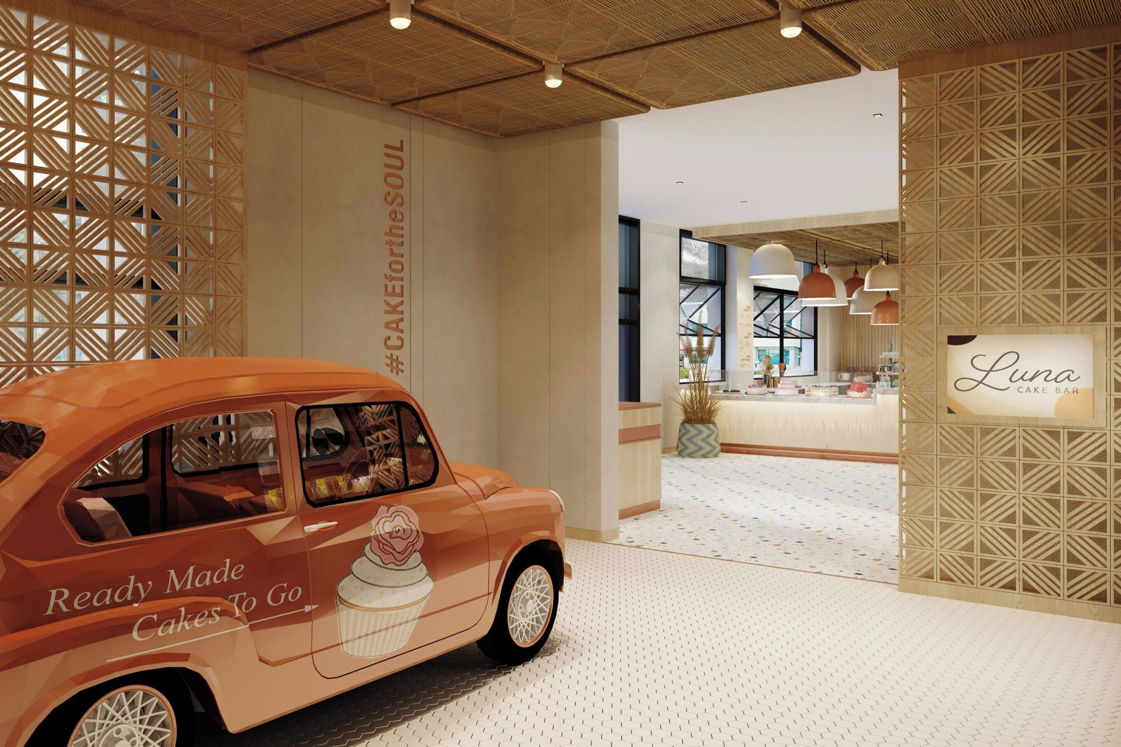Un interior moderno con una entrada temática de automóviles, una barra de pasteles y un letrero que dice "Luna".