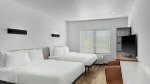 A modern hotel room with two beds, a TV, and a desk. - StudioRes by Marriott Greensboro Airport (Greensboro)