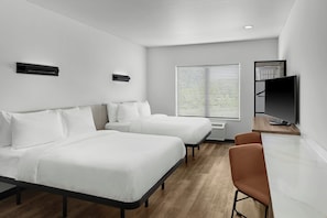 A modern hotel room with two beds, a TV, and a desk. - StudioRes by Marriott Greensboro Airport (Greensboro)