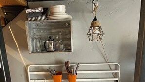 A compact kitchenette with a stainless steel sink, a microwave, and a small countertop. - Charming 1-Bedroom In Cozy, Rural Hesperus - Perfect For A Quiet Getaway (Hesperus)