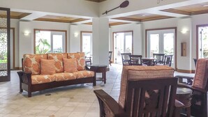 A spacious lobby with a sofa, chairs, and a dining area. - HGVC Point At Poipu 2 Bed 2 Bath Unit (Koloa)