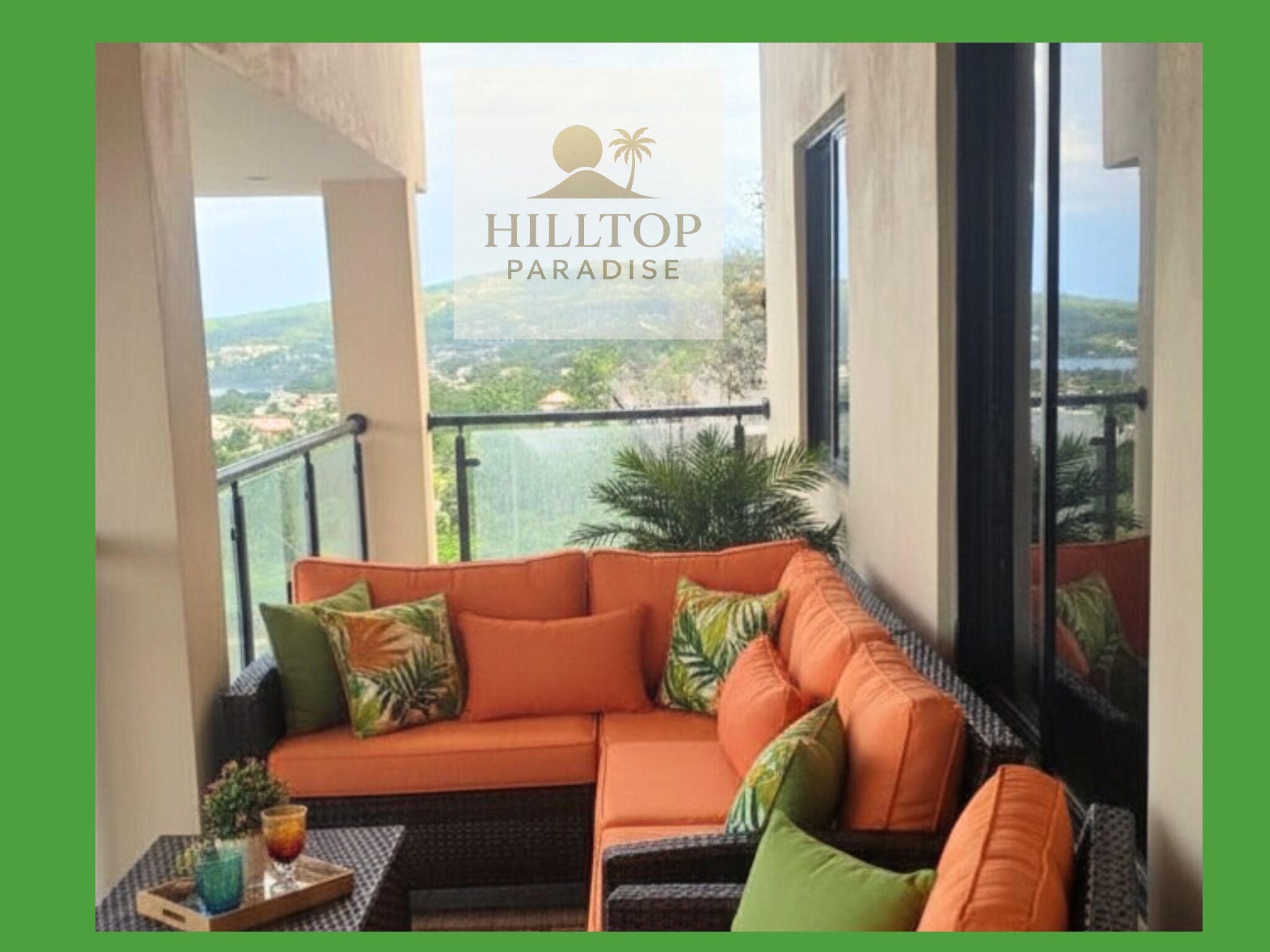 A balcony with a sofa and a tray table, overlooking a scenic landscape.