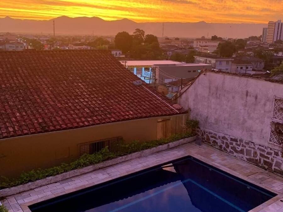 A swimming pool with a view of a cityscape at sunset.