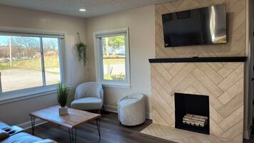 TV connectée, cheminée, livres