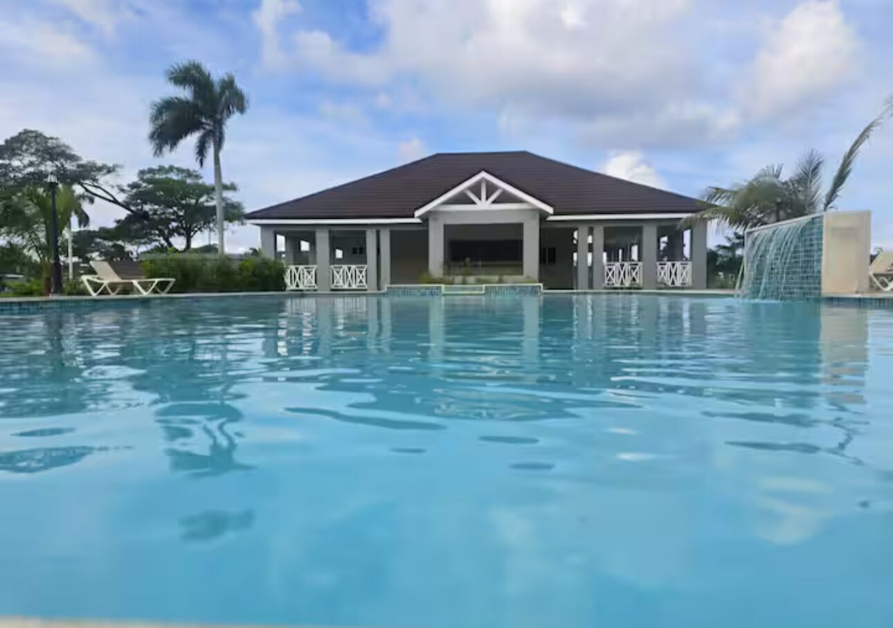 A swimming pool with a building in the background.