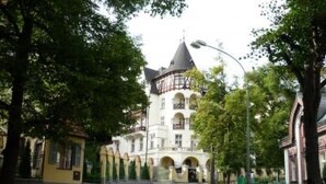 A building with a tower, arched windows, and a gated entrance. - U SEMUSHKY Apartment 3 by Interhome (Pernink)