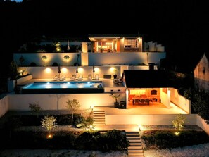 A modern two-story house with a swimming pool, outdoor seating, and a fireplace. - Luxury Villa Dobri Dida by Interhome (Donji Vinjani)