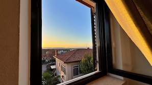 A window with a view of a residential area, including houses and a clear sky. - Apartment Katarina by Interhome (Krk/Milohnići)