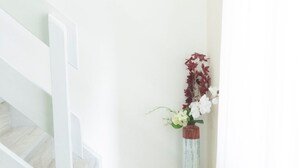 A staircase with a white railing leading to a landing. A framed picture hangs on the wall above the landing. - Jasnica by Interhome (Krk/Milohnići)
