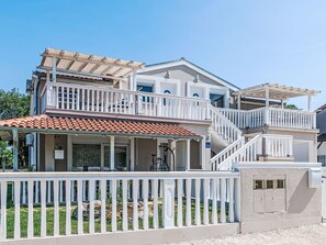 A two-story building with a balcony, a covered patio, and a staircase. - Ema Red mit Parkplatz, Terrasse und Grillmöglic by Interhome (Medulin)