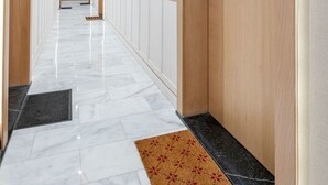 A hotel hallway with wooden doors numbered 46 and 42, marble flooring, and a doormat at the entrance. - Charmante Wohnung 42 by Interhome (Casablanca)