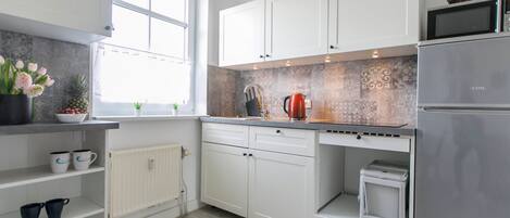 Fridge, microwave, cookware/dishes/utensils