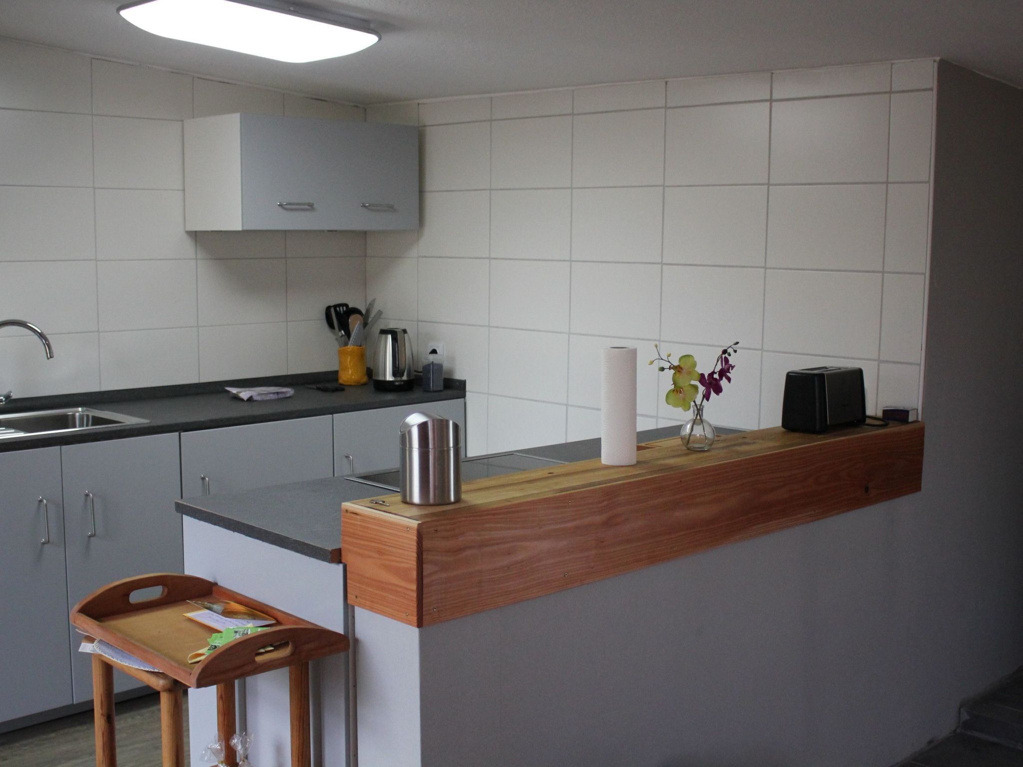 Een koelkast, een oven, een vaatwasser, kookgerei, borden en bestek