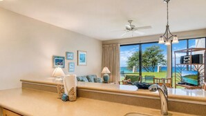 A kitchen with a large window, a ceiling fan, and a view of the outdoors. - Napili Point | Oceanfront 2 BR, Sleeps 8 | Car Incl. w/ 6+ Nights | NAP ML-3494 by KBM (Lahaina)