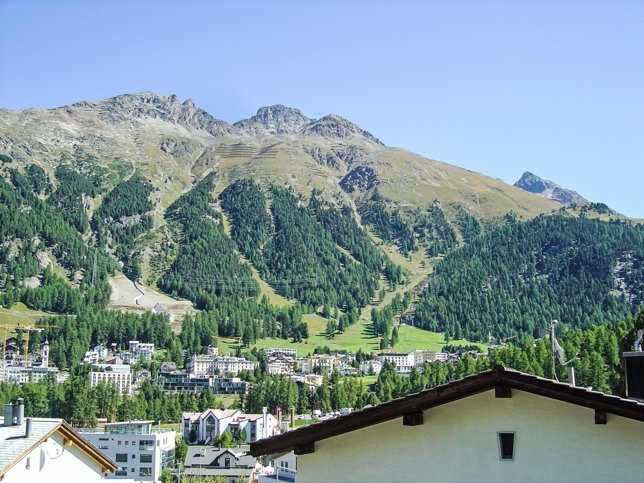 A mountain landscape with a town in the foreground.