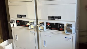 A stacked washer and dryer unit with a notice label, control panel, and a price tag of $1.00. - Remodeled studio in the heart of  historic downtown Durango! (Durango)