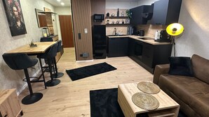 A modern apartment with a kitchen, dining area, and living room. - Winterberg by Interhome (Winterberg)